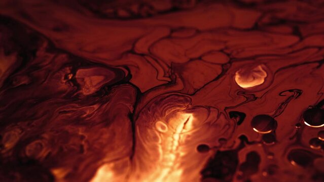 Dark red and black acrylic colors colliding in a fantasy lava abstract background. 