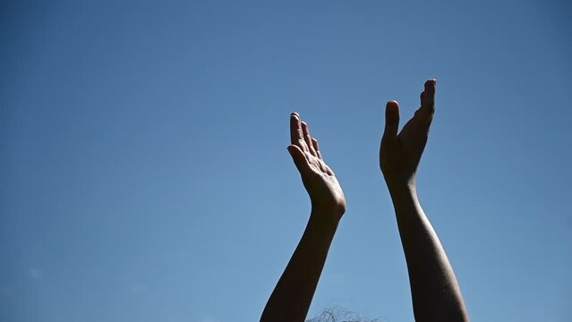 Close-up of female hands against the blue sky during the dance. Video 360 degrees. 