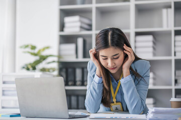 Fototapeta na wymiar Stressed millennial Asian businesswoman or female manager having a serious use laptop with her business client while working in the office.