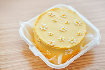 Beautiful cake with daisies made of cream and mastic, yellow summer cake
