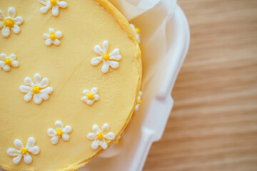 Beautiful cake with daisies made of cream and mastic, yellow summer cake