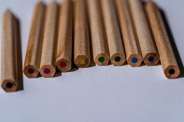 Pile of colorful wooden pencils on white background