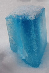 Colored ice brick made using a milk carton. For children's plays.