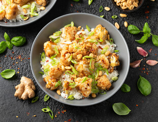 Kung Pao Cauliflower with rice, peanuts and spices. Healthy vegan food.