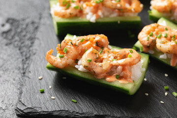 Cucumber Shrimp Sushi Boats with Spicy Mayo, Rice, Chives and sesame seeds