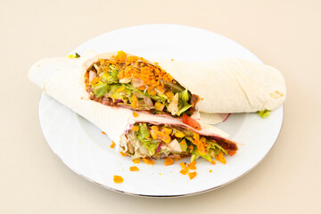 Cig kofte (raw meatball) with lettuce, tomato, pickle and lemon, hot Chee kofta. Turkish local raw food concept.Table scene of assorted take out or delivery foods. Doritoslu cig kofte durum.