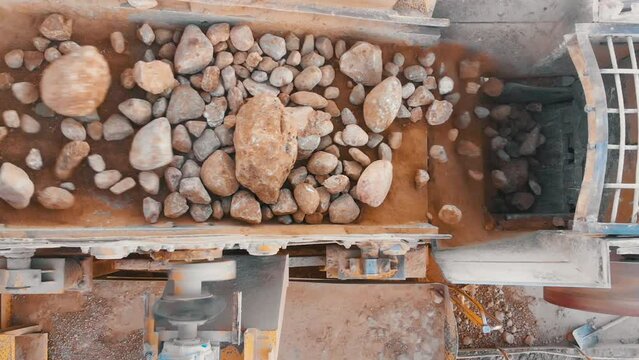 Stone jaw crusher plant. Sand and Stone Making Plant and Belt conveyor in mining quarry. Sand crushing and bulk materials for construction. Screening in open-pit mining. Stone crushing plant.