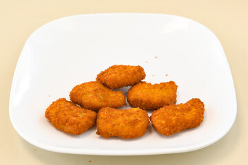 Fried Chicken breast hot crispy strips crunchy chicken tenders  isolated on white background.Nuggets isolated on white background on a plate