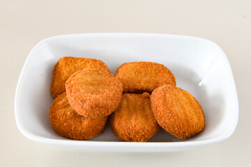 Fried Chicken breast hot crispy strips crunchy chicken tenders  isolated on white background.Nuggets isolated on white background on a plate