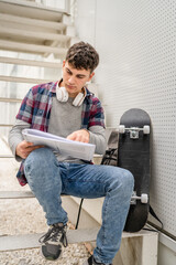 Young man teenager caucasian student with books read study at campus