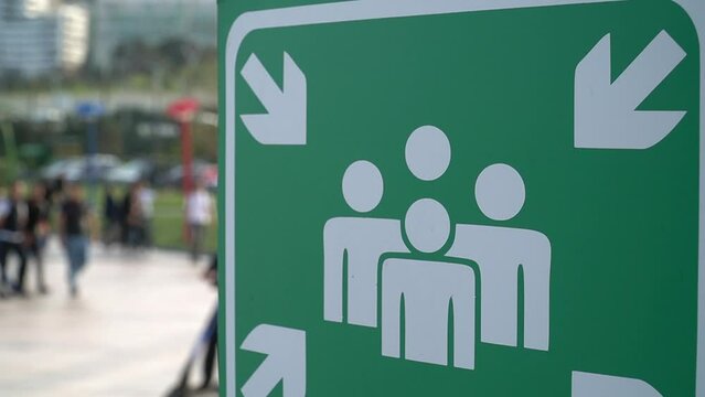 Green and white sign indicating the ASSEMBLY POINT in case of fire and emergency