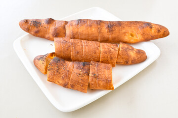 Turkish style meat stuffed filo dough borek served kol boregi. Cheese and minced pie are sliced on a marble background. Turkish name: Kol Boregi, ispanakli, kiymali, Su Boregi
