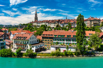 Fototapeta na wymiar View of the Bern old city center and Nydeggbrucke bridge over river Aare, Bern, Switzerland. Bern old town with the Aare river flowing around the town on a sunny day, Bern, Switzerland.