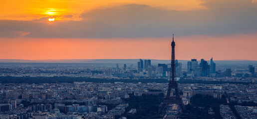 View of Paris with Eiffel Tower from Montparnasse building. Eiffel tower view from Montparnasse at sunset, view of the Eiffel Tower and La Defense district in Paris, France.