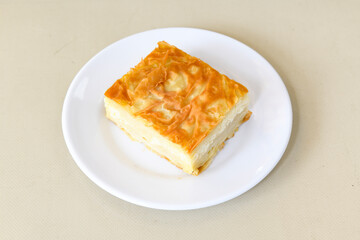 Turkish style meat stuffed filo dough borek served kol boregi. Cheese and minced pie are sliced on a marble background. Turkish name: Kol Boregi, ispanakli, kiymali, Su Boregi