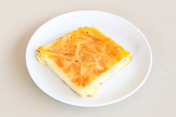 Turkish style meat stuffed filo dough borek served kol boregi. Cheese and minced pie are sliced on a marble background. Turkish name: Kol Boregi, ispanakli, kiymali, Su Boregi