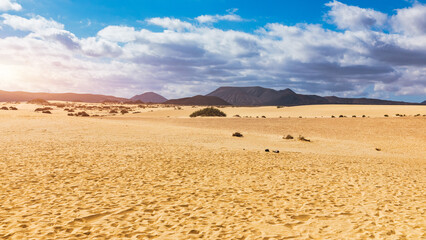 Sand dunes, Las Dunas de Corralejo, Corralejo Natural Park, dramatic cloud formation, Fuerteventura, Canary Islands, Spain. Sand dunes landscape, Corralejo, Fuerteventura, Canary Islands, Spain.