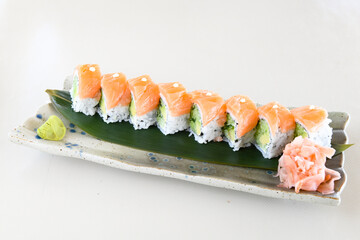 Variety of sushi rolls are presented on a plate, showcasing the colorful and fresh ingredients.