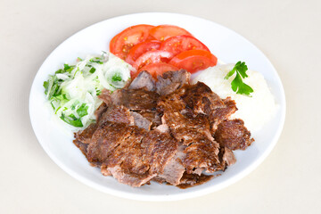 Turkish and Arabic Traditional Ramadan doner kebab with tasty tomato sauce and rice or turkish...
