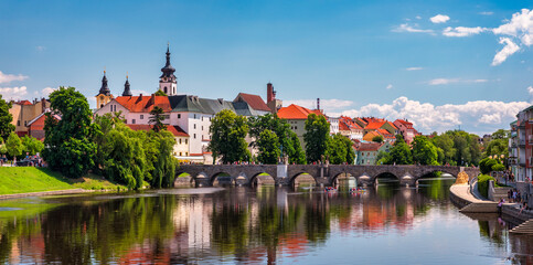 Fototapeta premium Medieval Town Pisek and historic stone bridge over river Otava in the Southern Bohemia, Czech Republic. Pisek Stone Bridge, the oldest preserved early Gothic bridge in the Czech republic.