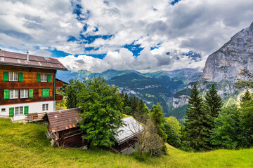 Village of Murren in the Swiss Alps. Village Murren surrounded by mountain peaks of Alps. Murren mountain village with Lauterbrunnen Valley and Swiss Alps, Jungfrau region, Switzerland, Europe.