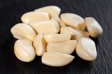 Fototapeta na wymiar Garlic cloves. Raw garlic isolated on black background. Vegetable