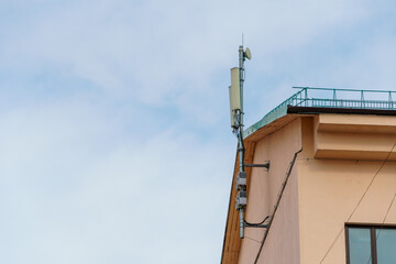 New GSM antennas on the roof of a residential building in the city for transmitting a 5g signal are a danger to human health. Radiation pollution of the environment through cell towers.