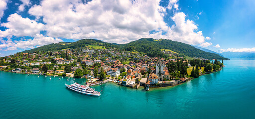 Oberhofen panoramic view at Lake Thunersee in swiss Alps, Switzerland. Town of Oberhofen on the Lake Thun (Thunersee) in Bern Canton of Switzerland. Oberhofen town on Lake Thun, Switzerland.