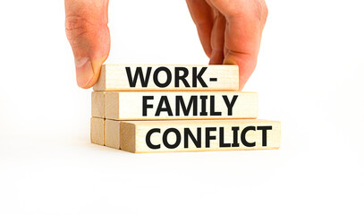 Work-family conflict symbol. Concept words Work-family conflict on wooden block on a beautiful white table white background. Businessman hand. Business work-family conflict concept. Copy space.