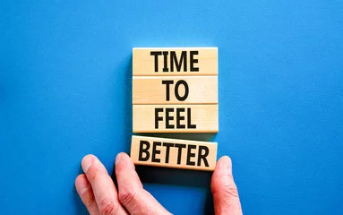 Fotobehang Time to feel better symbol. Concept words Time to feel better on wooden block. Beautiful blue table blue background. Businessman hand. Motivational business time to feel better concept. Copy space © Dzmitry