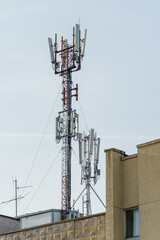 New GSM antennas on the roof of a residential building in the city for transmitting a 5g signal are a danger to human health. Radiation pollution of the environment through cell towers.