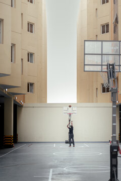 street basketball in the court in between two tall buildings, ball bouncing sounds, middle east, passion, love, 
