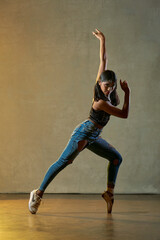  young beautiful ballerina posing and dancing in a studio   