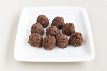 Various handmade chocolates with nuts arranged on  table with peanut butter and cinnamon sticks