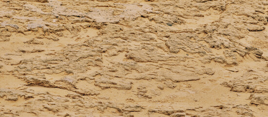 Abstract brown sand color background from sand texture. Banner with a rough surface of sand