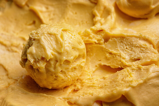 A scoop of mango ice cream close-up
