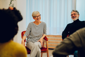 Senior woman talking about her mental health on a group therapy session