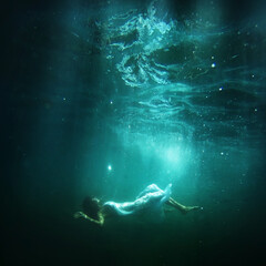 Woman floats underwater, dream fantasy