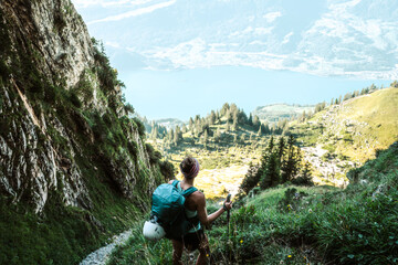 Sporty woman enjoys view from hike trail on lake Walensee in the morning. Schnürliweg, Walensee,...