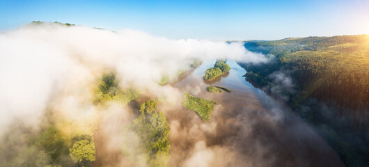 In the morning, a thick white fog hovers over the river. Dniester canyon national park, Ukraine, Europe.