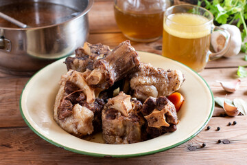 Beef bones to make bone broth for a healthy diet. Saucepan with bone broth.