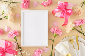 Happy Mother's Day concept. Top view photo of plate cutlery napkin gift boxes with bows carnation flowers and paper hearts on beige background. Flat lay with empty frame for text or advert