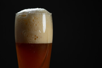 A glass of delicious craft beer served on an authentic beer glass, to be used as a background