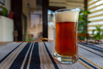 A glass of delicious craft beer served on an authentic beer glass, to be used as a background