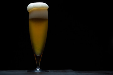 A glass of delicious craft beer served on an authentic beer glass, to be used as a background