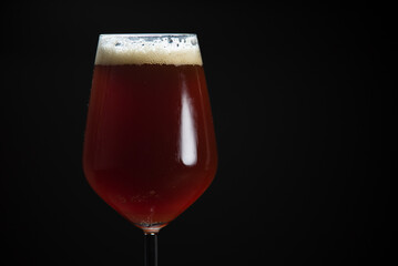 A glass of delicious craft beer served on an authentic beer glass, to be used as a background