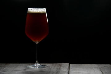 A glass of delicious craft beer served on an authentic beer glass, to be used as a background