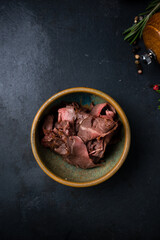 Pieces of boiled beef in a ceramic bowl.