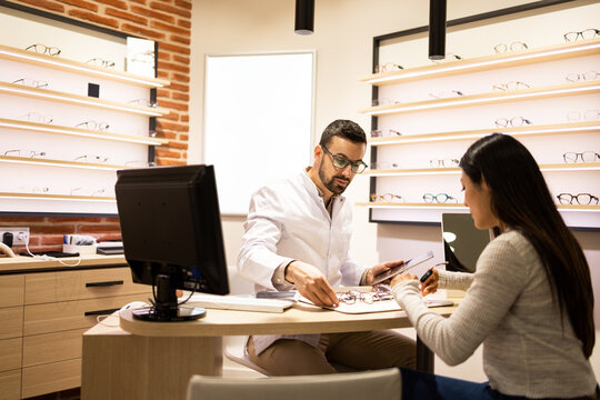 Specialist and customer with different eyewear at store