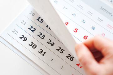 flipping through the pages of the flip calendar. 